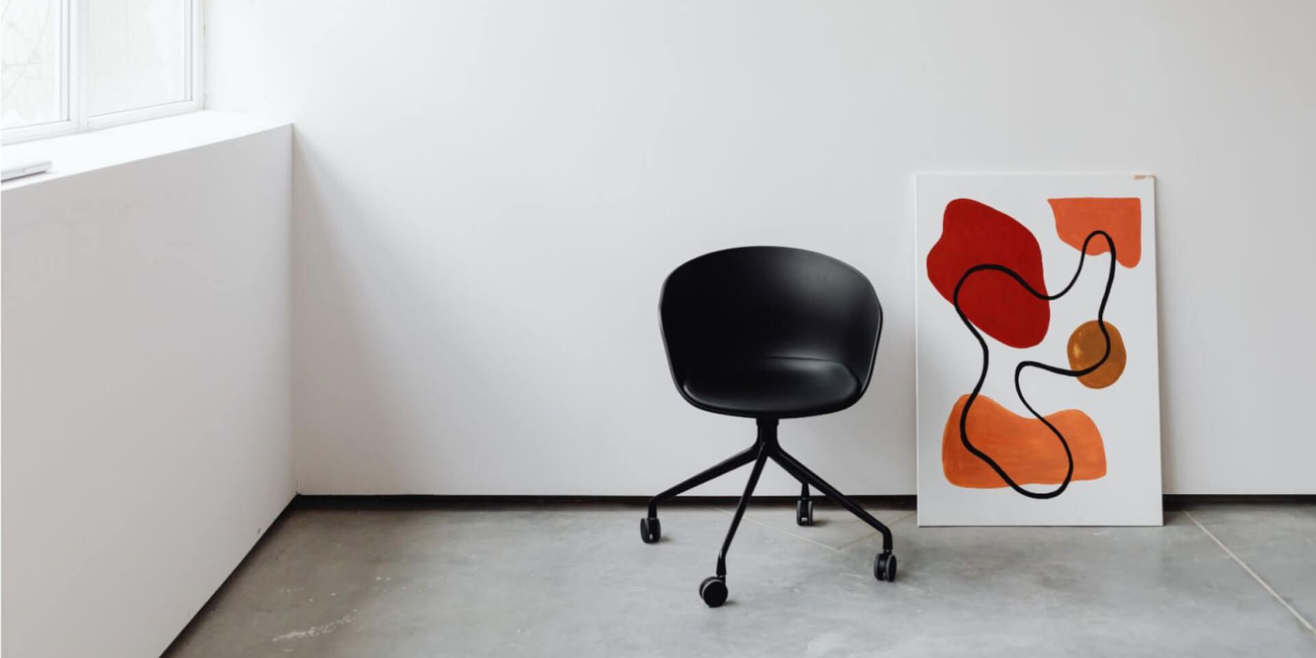 Can a Rolling Chair be a Clinical Tool? A photo of a rolling chair next to a piece of abstract art.